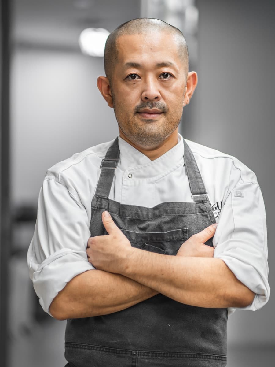 Editorial black-and-white portrait of executive chef Elias Thorne in a white chef's coat.