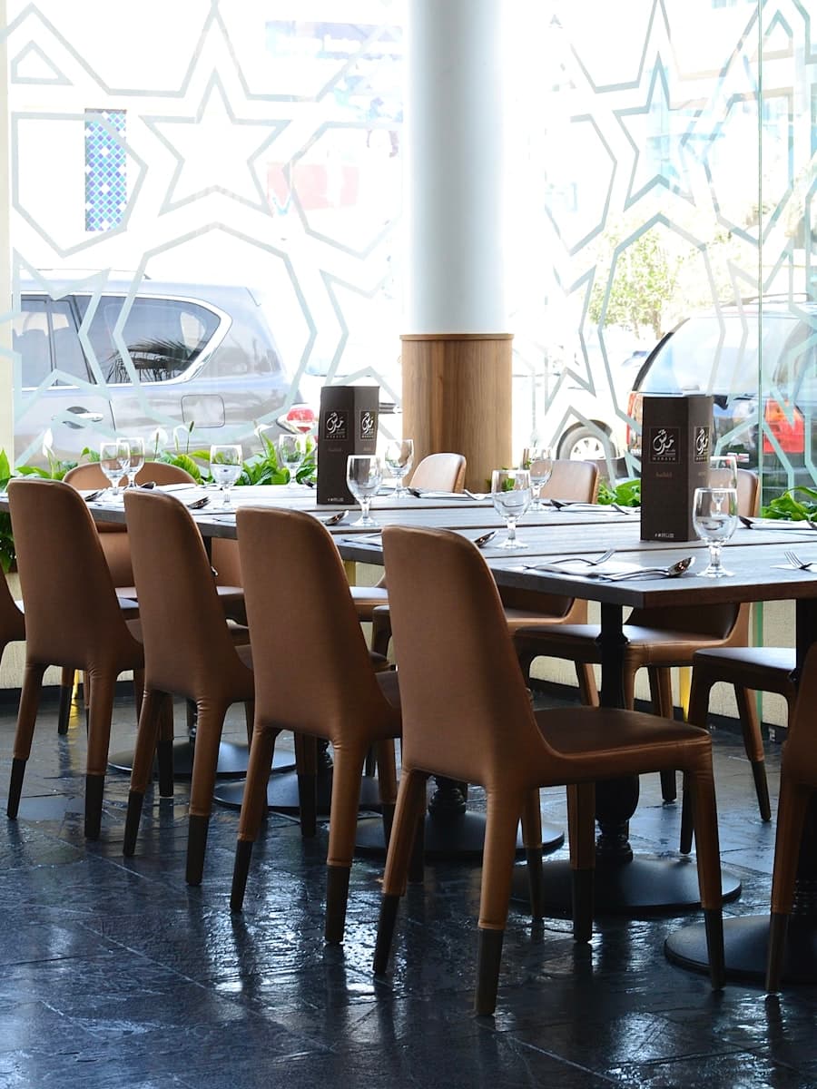 Impeccably set dining table with polished cutlery and crystal glassware.